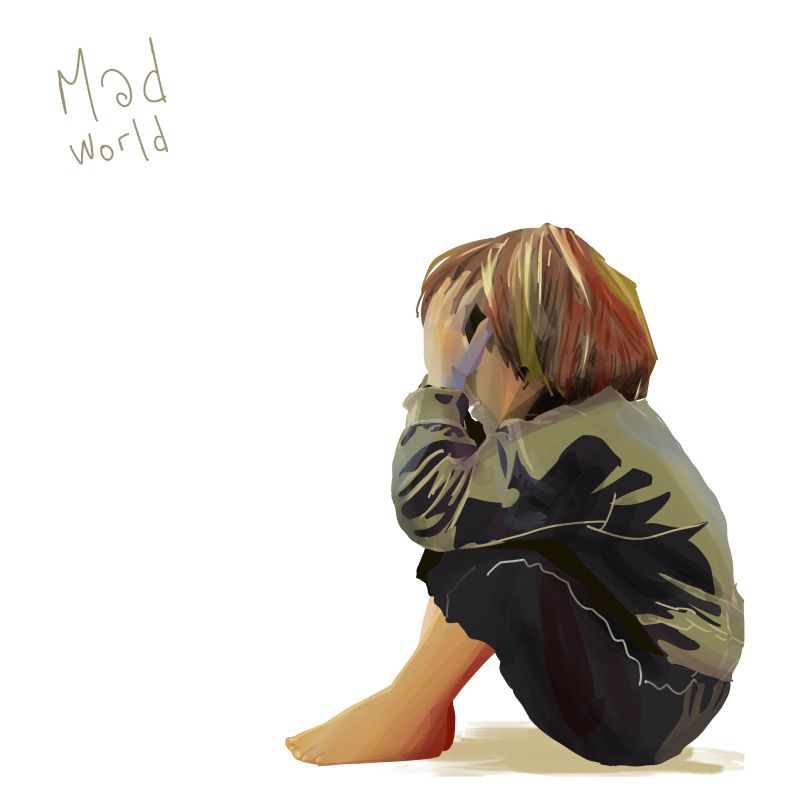 Petit garçon assis par terre qui se prend la tête dans les mains. Le mot mad world lui fait face.